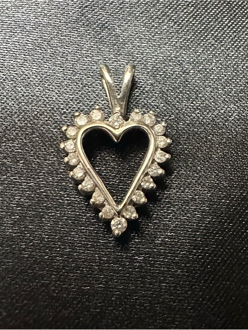 Vintage 10K white gold open-heart pendant with a halo of small diamonds.